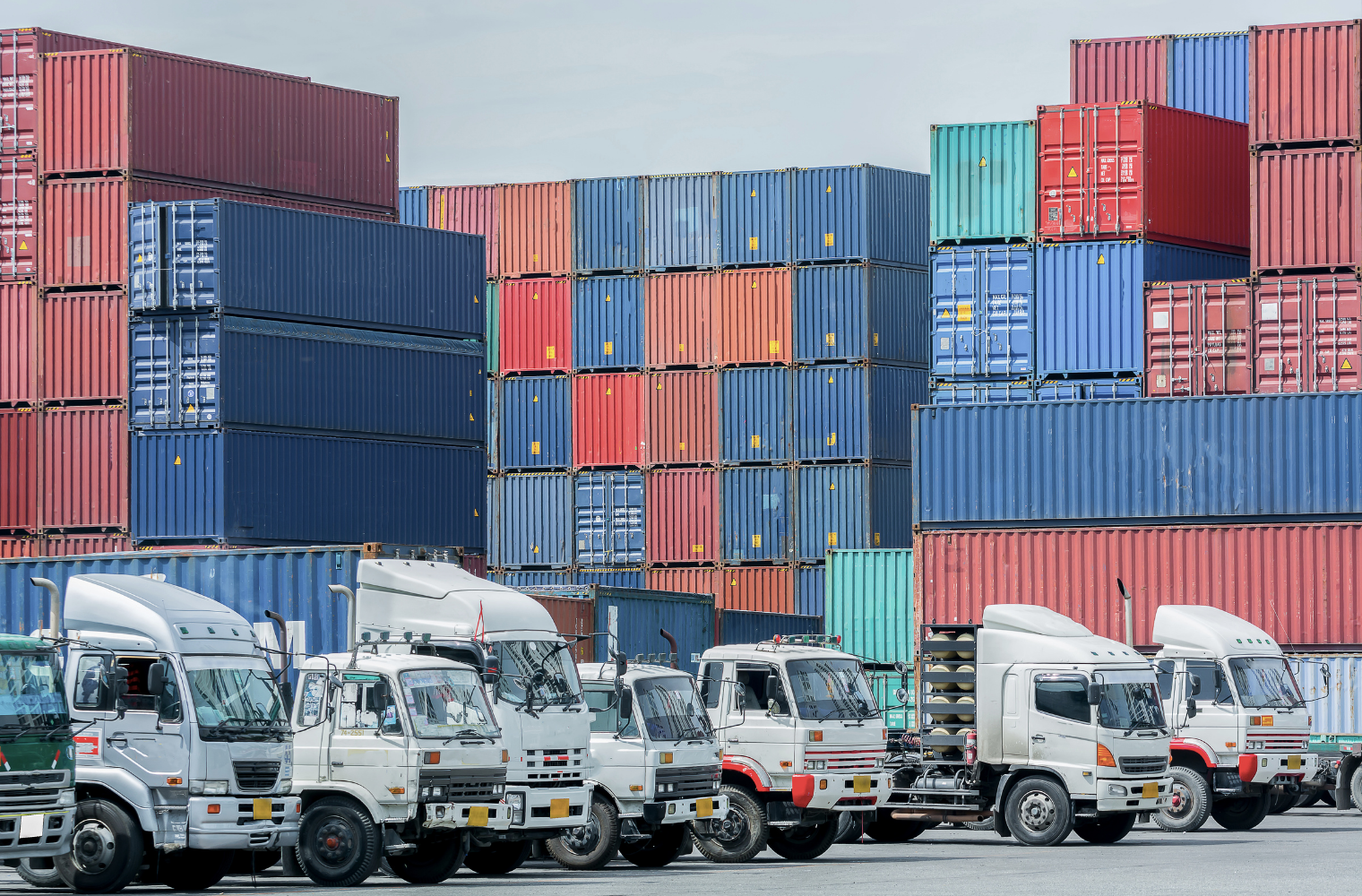 "Long-haul trucks at a logistics hub or vehicles on a highway, indicating communication in logistics management.