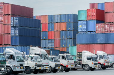 "Long-haul trucks at a logistics hub or vehicles on a highway, indicating communication in logistics management.